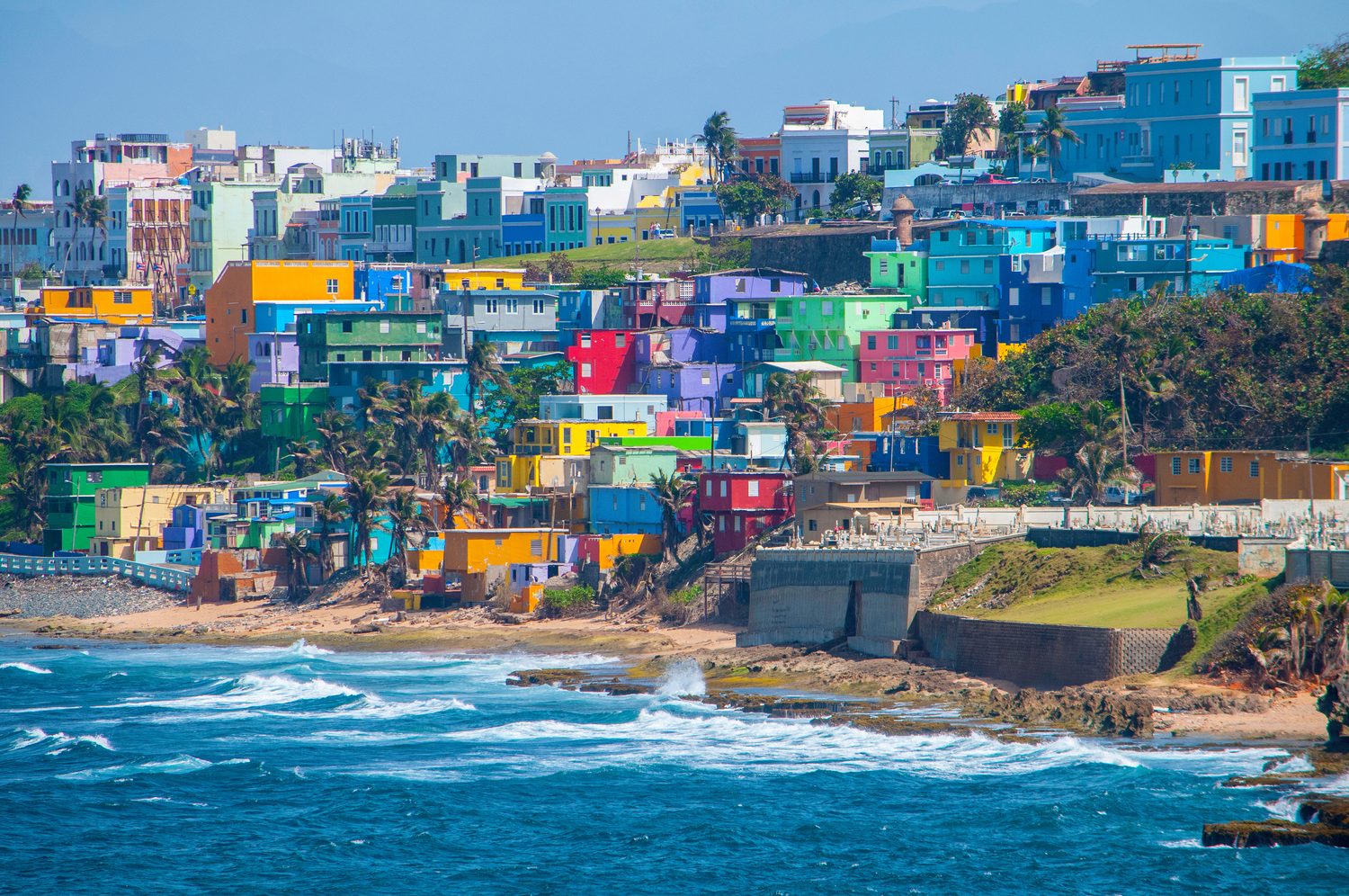 The colorful houses of La Perla cascading toward the surf below Old San Juan's sea wall.