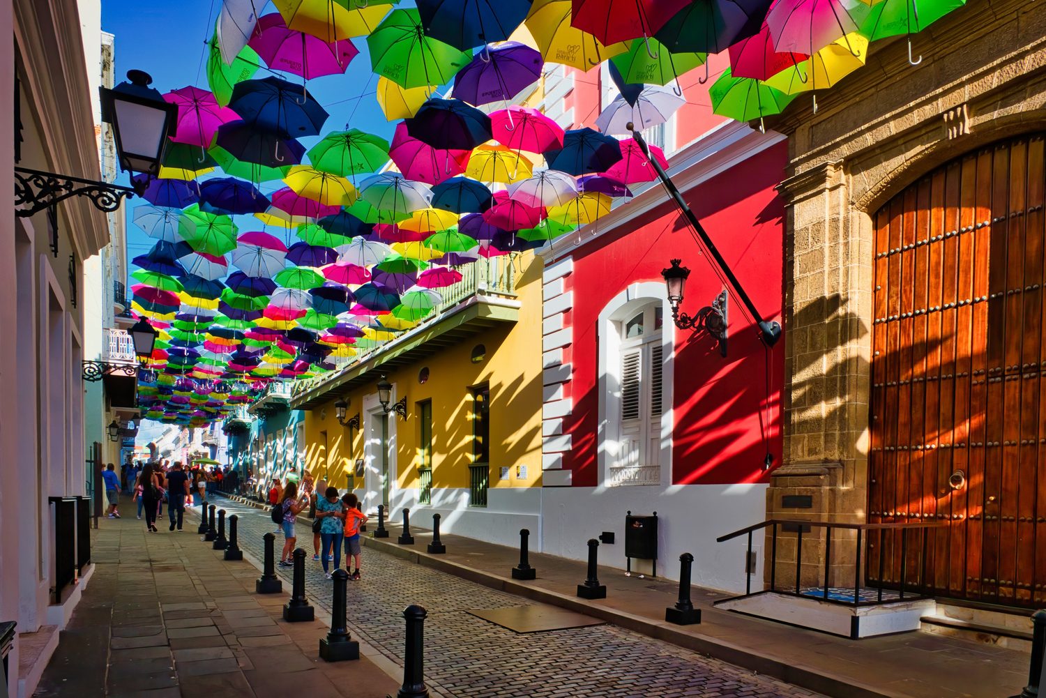 The umbrella canopy strung above Calle Fortaleza in Old San Juan, over colorful colonial buildings.