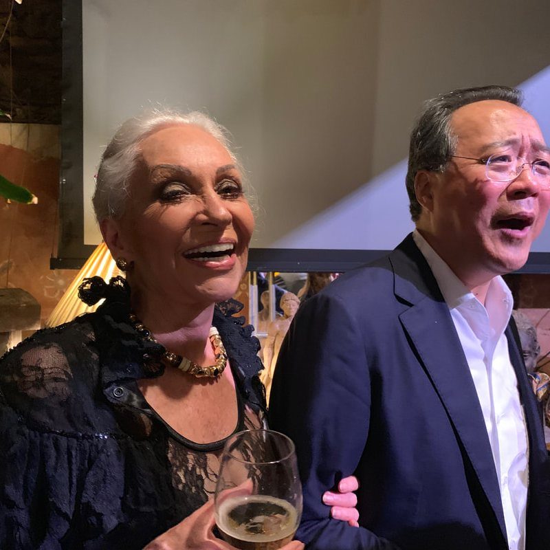 Jan D'Esopo laughing beside the cellist Yo-Yo Ma at The Gallery Inn.